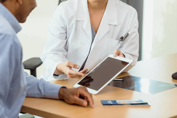 istock Patient views test results with doctor 1302507725