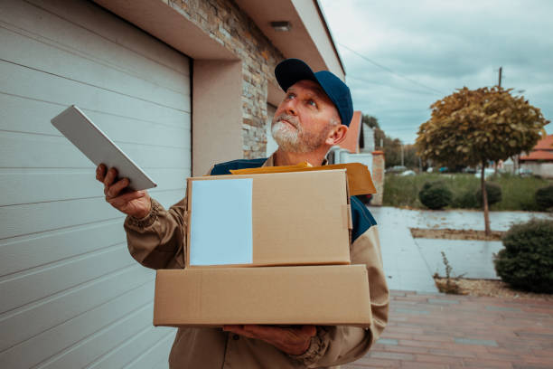 istock Postman delivery a package to a customer 1302507900