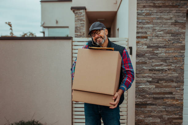istock Courier having phone conversation with customer and delivering shipment to customer 1302509786