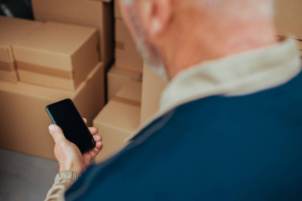 istock Courier checking address of costumer on his cellphone 1302509899