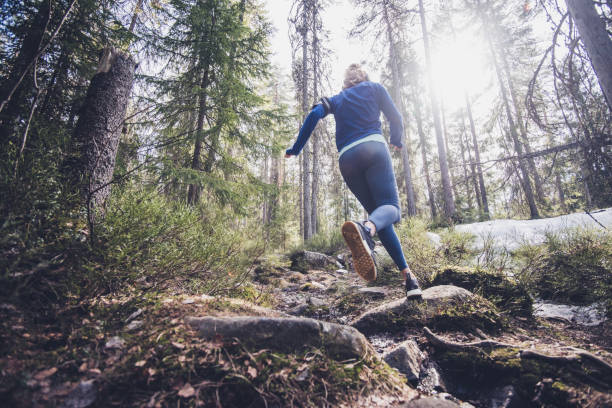 istock Woman trail runner running in forest. 1302511793