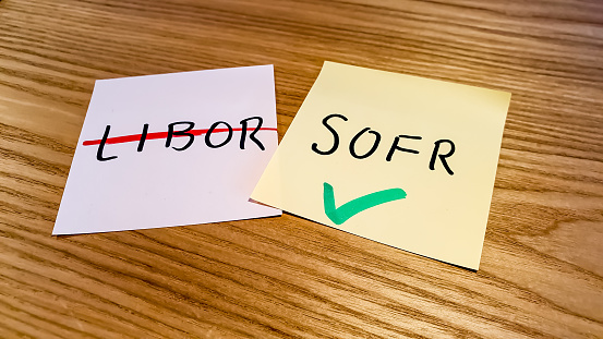 Abbreviations for London Interbank Offered Rate and Secured Overnight Financing Rate written on adhesive notes in anticipation for the discontinuation of LIBOR, transitioning into SOFR