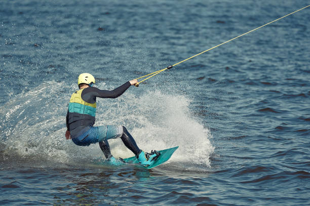 istock the guy is riding a wakeboard on the river. Active and Extreme Sports 1302514853