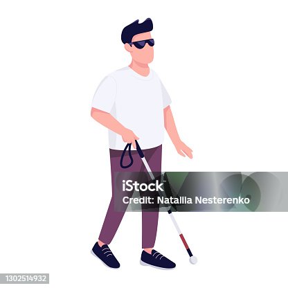 Young blind man in dark glasses walking with a cane stick on the