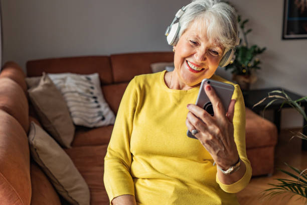 istock Happy senior woman at home, using smart phone 1302515701