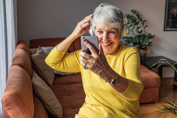 istock Happy senior woman at home, using smart phone 1302515763
