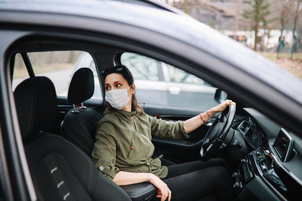 istock Female carshare driver during the pandemic talking to the customer 1302517864