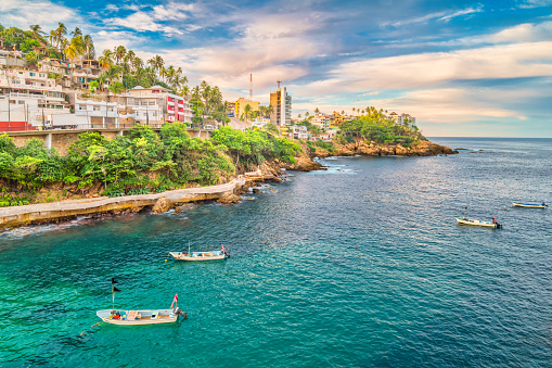 Pacific Coastline with boats in Acapulco Guerrero Mexico on a sunny day.