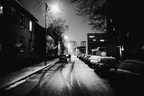 Car infront old wooden apartment building, snowfall. Tallinn, Estonia