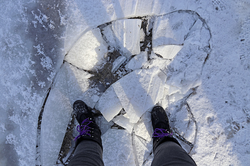 Dangerous thin ice. A woman broke into the ice in winter.