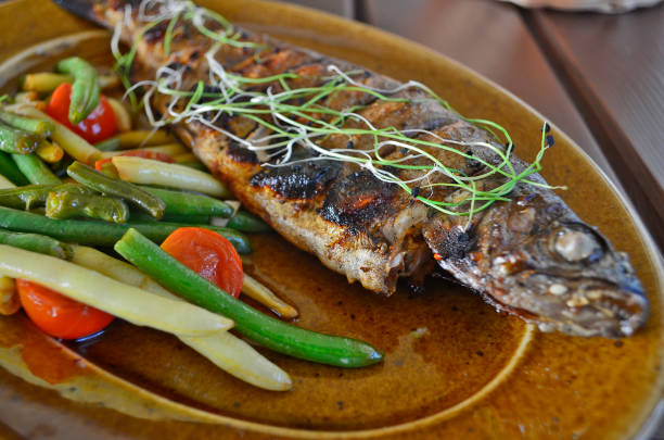 istock Baked trout with vegetables, restaurant serving. 1302523115