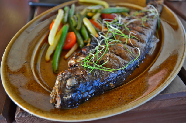 istock Baked trout with vegetables, restaurant serving. 1302523120