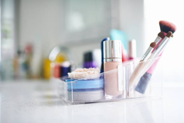 istock Make-up products and brushes in plastic container in modern bright bathroom 1302524966