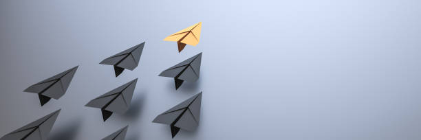 istock Leadership concept, yellow leader plane leading black planes, on black background with empty copy space on right side 1302525707