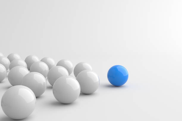Leadership concept, blue leader ball leading white balls, on white background with empty copy space stock photo
