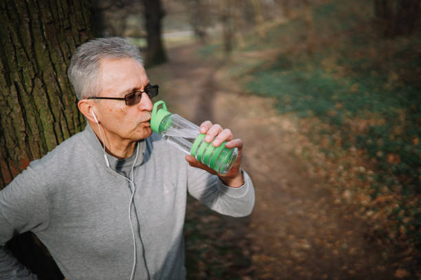 istock Senior man hiking outdoors, stopping for some relaxation 1302527461