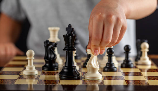 making a well calculated chess move - child prodigy imagens e fotografias de stock