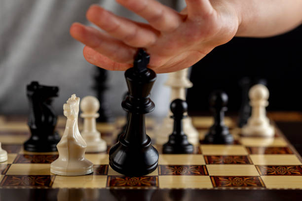 istock player resigns at a chess game by tipping over his king 1302529535