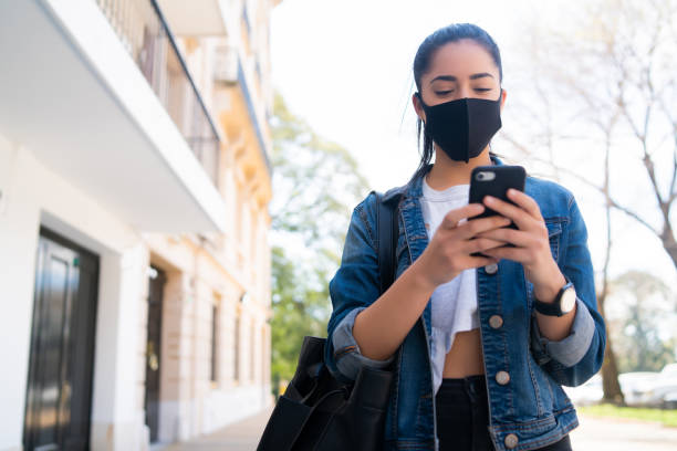 istock Young woman using her mobile phone outdoors. 1302531283