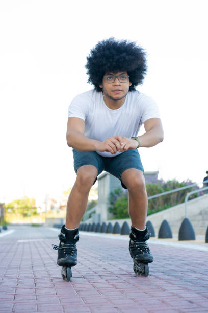 istock Latin man rollerskating outdoors. 1302531296