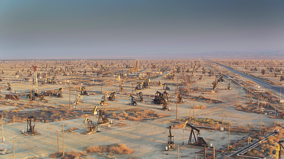 Drone shot of oil pump jacks in Missouri Triangle, Kern County, California. This intensive drilling operation is part of the South Belridge Oil Field in the San Joaquin Valley.