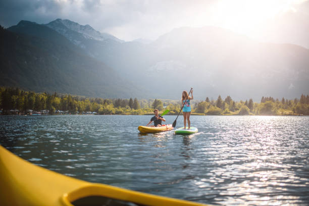 istock Paddleboarder and Flatwater Kayaker Exploring Lake Bohinj 1302532476