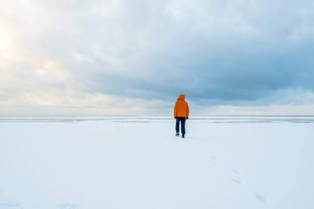 istock Lonely man in an orange jacket. 1302532557