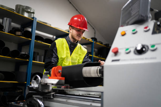 istock One young male factory worker working on the machine for rolling rubber compounds 1302532652