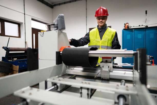 istock Young male factory worker working on the machine for rolling rubber compounds 1302532664