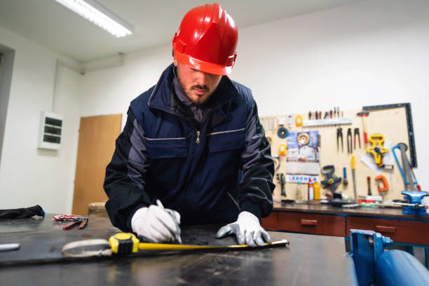 istock One young man, manual worker, using a meter to measure rubber black mixture in small production 1302532669