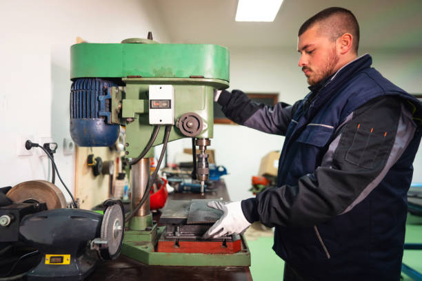 istock One young male manual worker working on a drill machine in a small production of endless rubber bands and belts 1302532690