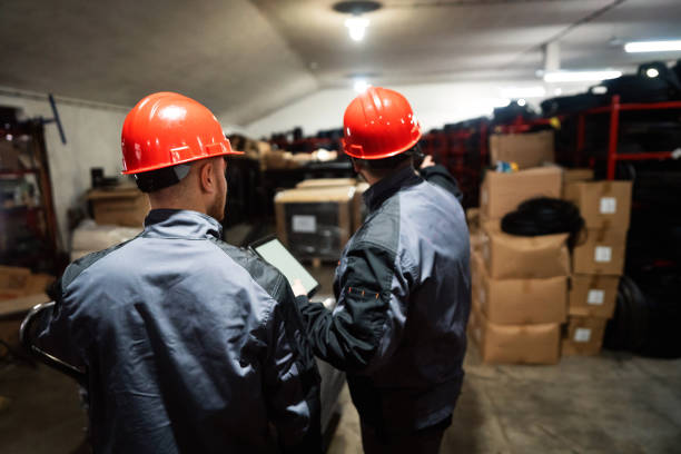 istock Two male warehouse workers sorting finished goods in a warehouse 1302532695