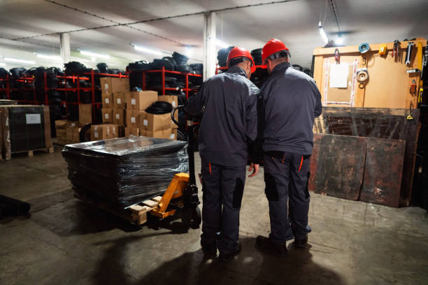 istock Two men sorting finished rubber mats for gym in warehouse 1302532698