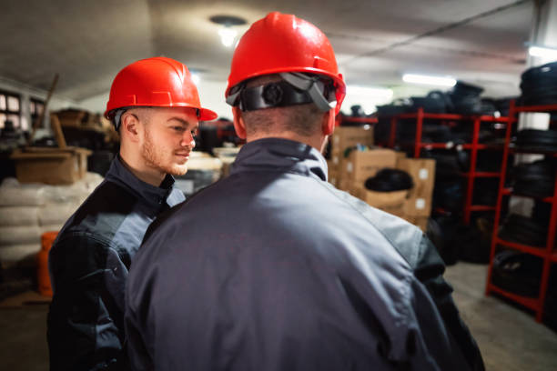 istock Two young warehouse workers sorting finished goods in warehouse of endless rubber bands and belts 1302532701