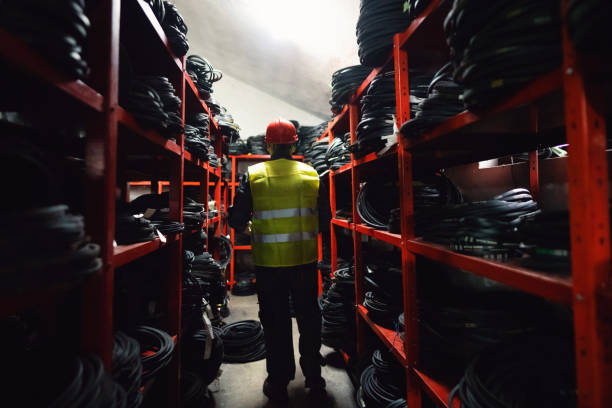 istock Young man, warehouse worker, working in warehouse of endless rubber bands and belts 1302532710