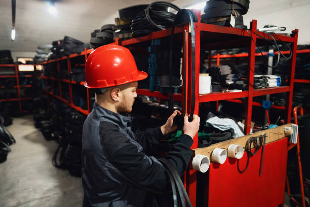 istock Young warehouse worker sorting finished goods in warehouse of endless rubber bands and belts 1302532712