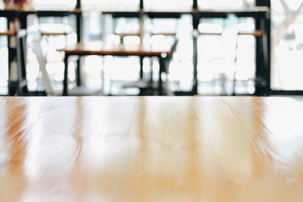 istock wooden table with cafe coffee shop blur background 1302532847