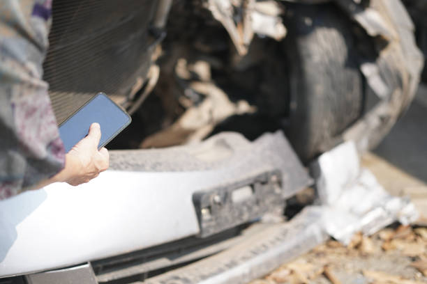istock hand take photo of crashed damaged broken car. automobile crash accident 1302532925