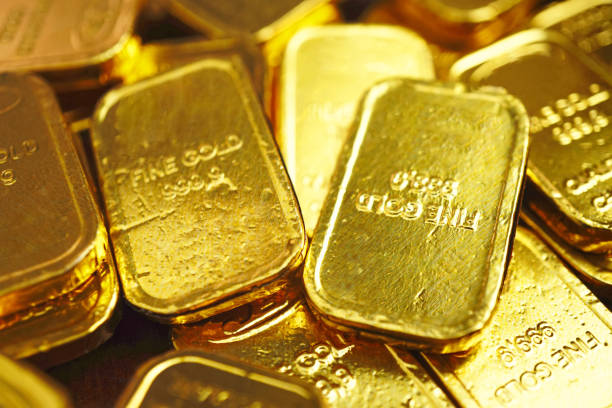 istock Selective focus on gold bars which spread on the table , investment concept . 1302533240