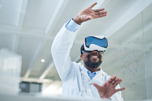 Shot of a mature scientist using a virtual reality headset while working in a lab