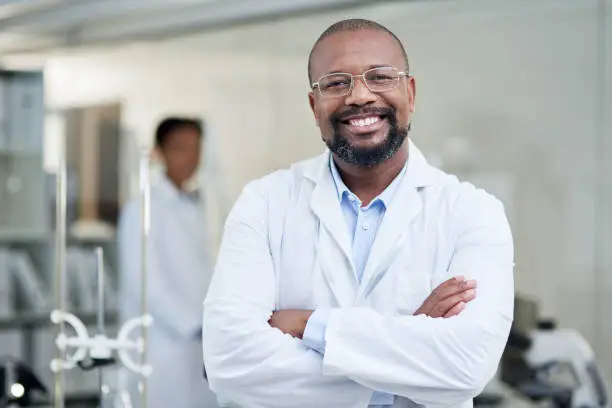Portrait of a mature scientist standing with his arms crossed in a lab