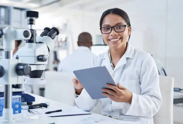 Portrait of a young scientist using a digital tablet in a lab