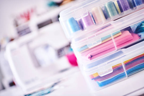 istock Sewing machine and craft supplies in modern bright craft room 1302536844