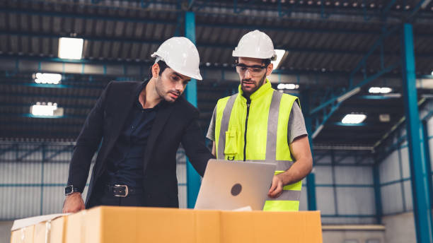 istock Two factory workers working and discussing manufacturing plan in the factory . 1302537627