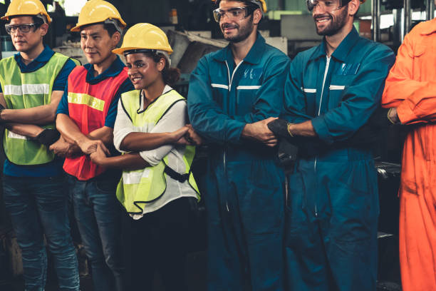istock Skillful worker stand together showing teamwork in the factory . 1302537871