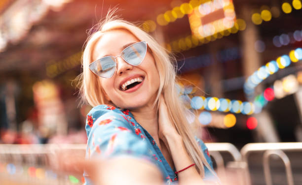 istock Stylish woman having fun in amusement park 1302538595