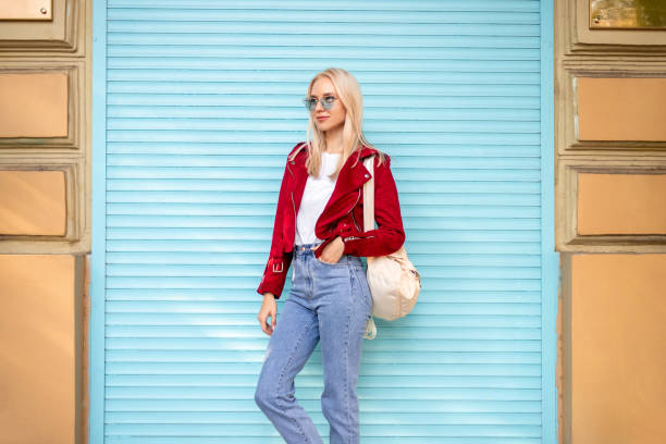 istock Stylish female leaning on wall 1302538608