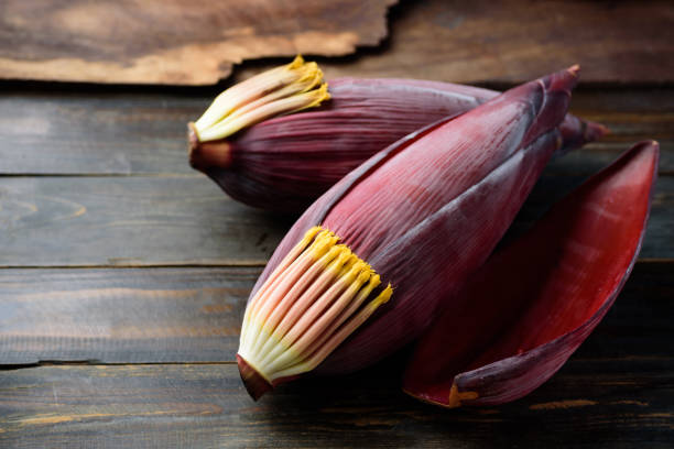 istock Banana blossom on wooden background 1302540172