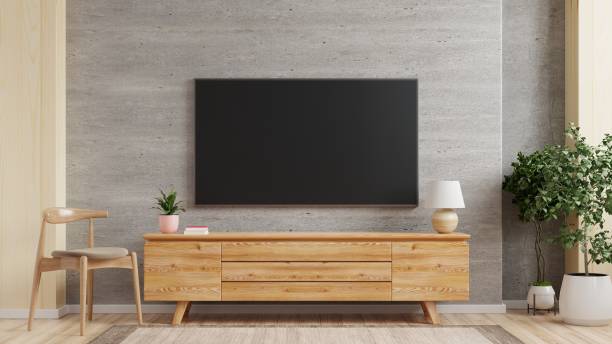 tv-wandmontage auf schrank die im modernen wohnzimmer die betonwand. - zimmer bildschirm stock-fotos und bilder