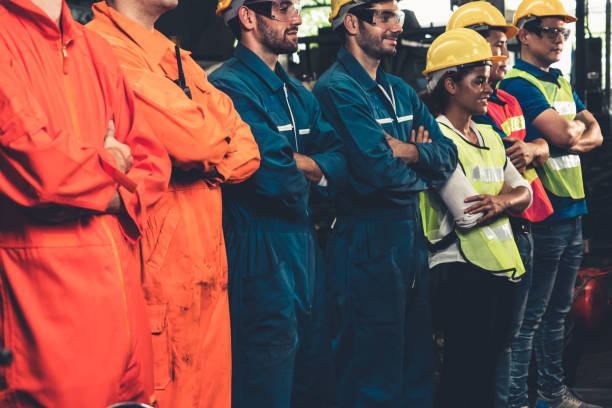 istock Skillful worker stand together showing teamwork in the factory . 1302542000
